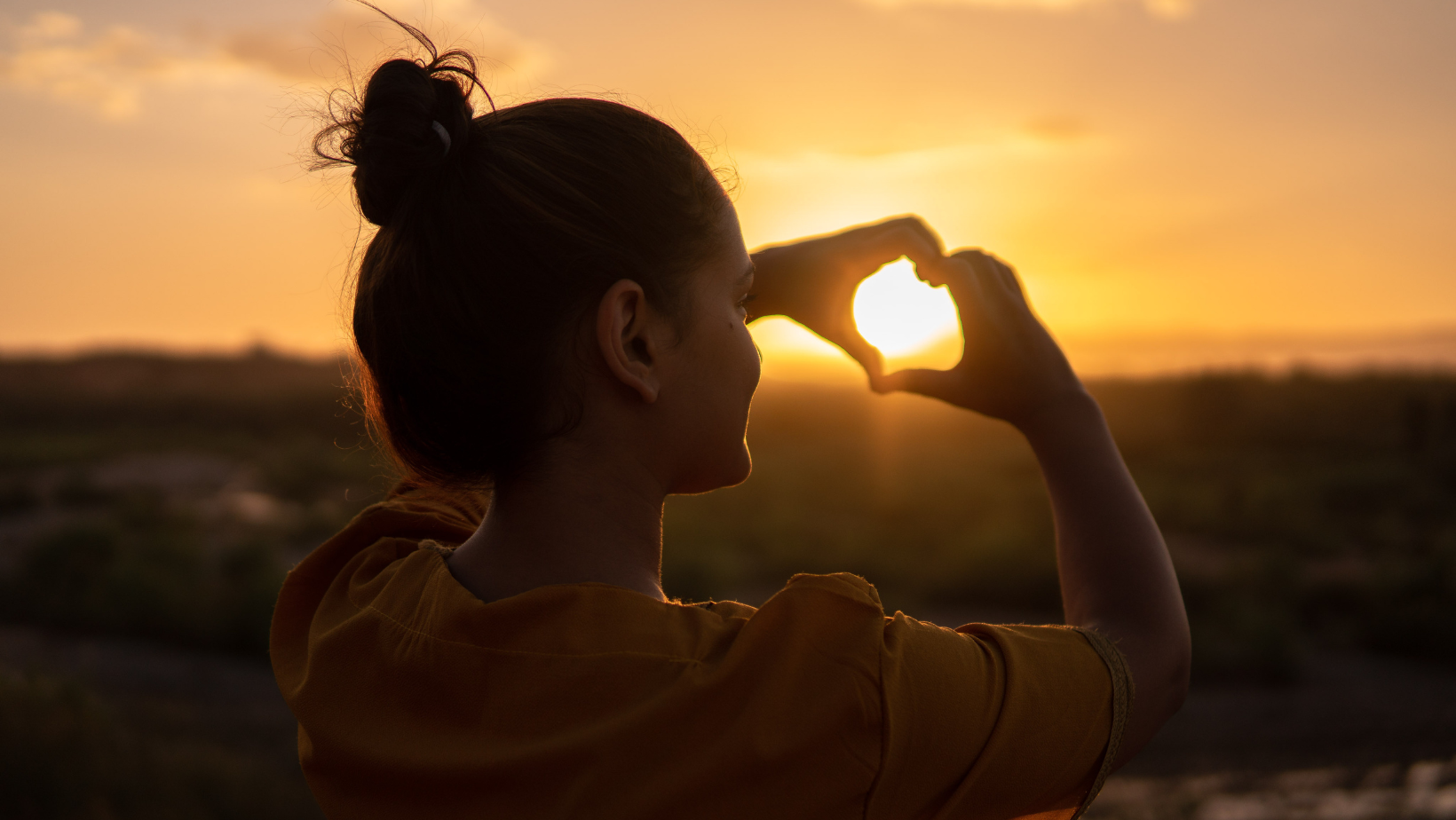 Women making heart shape with hands